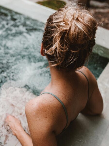 Woman sitting in spa tub